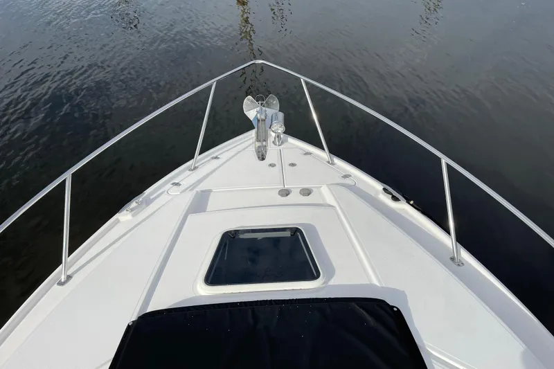 Slide: The Image of Bow view of 2012 Regal 35 Sport Coupe on calm water. - 15