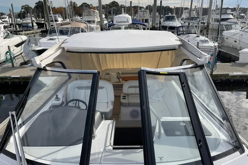 Slide: The Image of 2012 Regal 35 Sport Coupe docked at marina, showcasing open cockpit and seating area. - 16