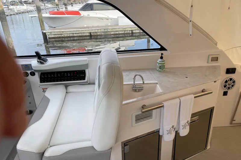 Slide: The Image of Interior of a 2012 Regal 35 Sport Coupe with helm seat and kitchenette. - 19