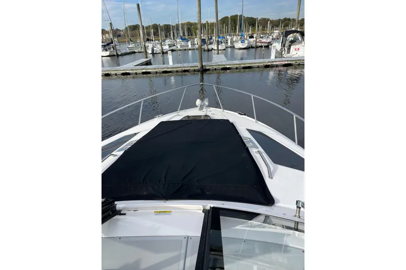 Slide: The Image of 2012 Regal 35 Sport Coupe yacht docked at marina, featuring sleek design and spacious deck. - 20