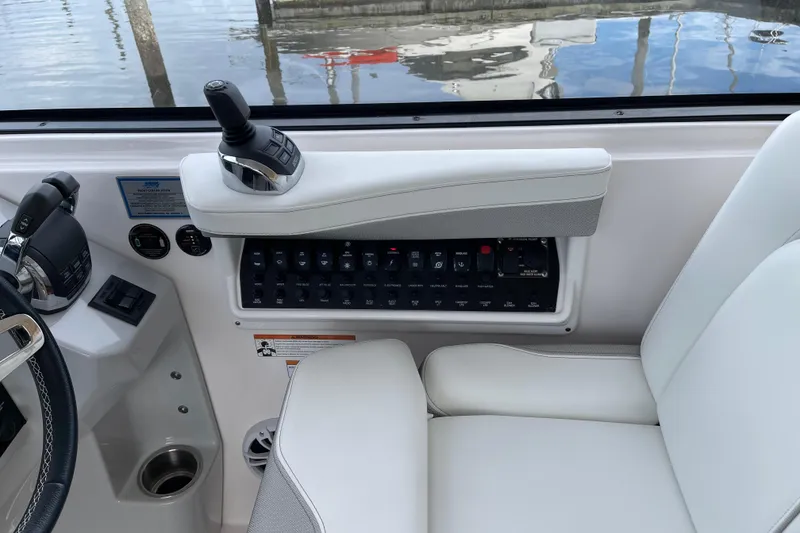 Slide: The Image of Control panel of a 2012 Regal 35 Sport Coupe boat with joystick and switches. - 23