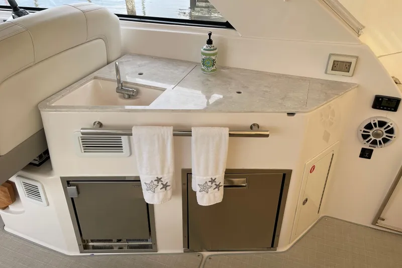 Slide: The Image of 2012 Regal 35 Sport Coupe yacht interior with sink, countertop, and storage cabinets. - 29