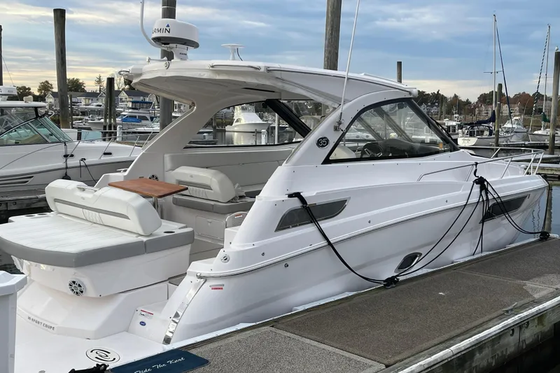 Slide: The Image of 2012 Regal 35 Sport Coupe docked at marina, showcasing sleek design and modern features. - 3