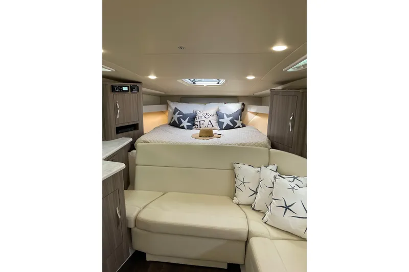 Slide: The Image of Interior of 2012 Regal 35 Sport Coupe with cozy bed and stylish decor. - 35
