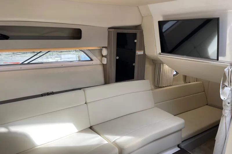 Slide: The Image of Interior of 2012 Regal 35 Sport Coupe with beige seating and mounted TV. - 38