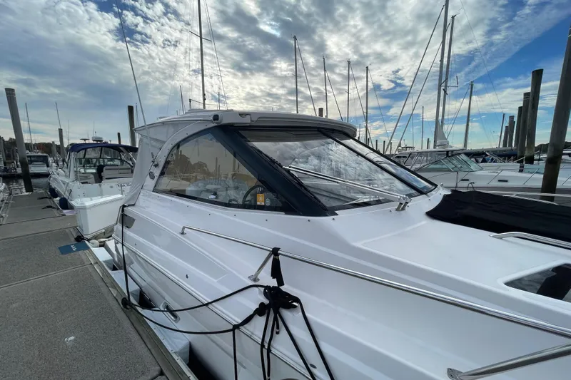 Slide: The Image of 2012 Regal 35 Sport Coupe docked at marina under cloudy sky. - 4