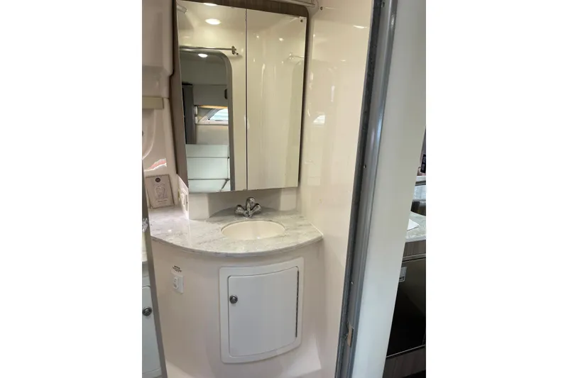 Slide: The Image of 2012 Regal 35 Sport Coupe bathroom with sink, mirror, and storage cabinet. - 44