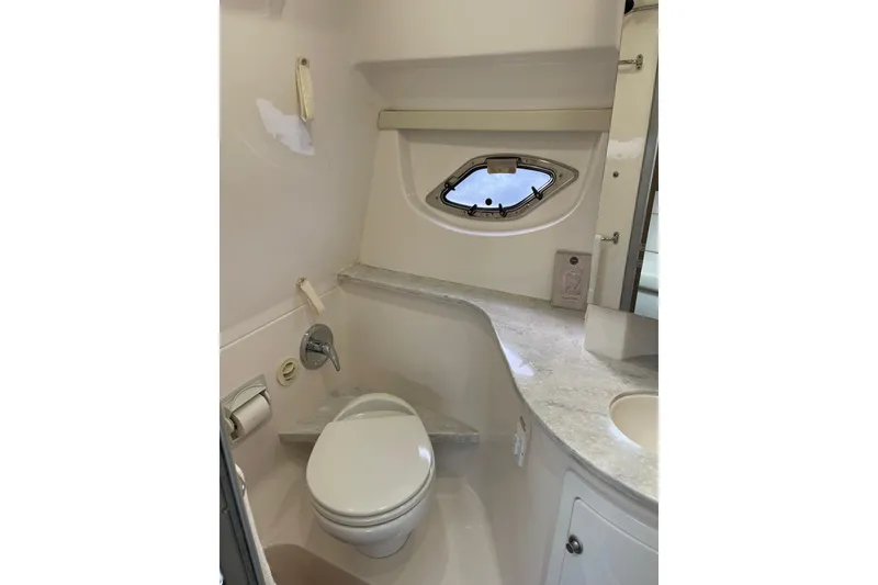 Slide: The Image of Bathroom interior of 2012 Regal 35 Sport Coupe with modern fixtures and porthole window. - 45