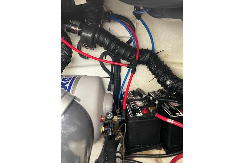 Slide: The Image of Engine compartment of a 2012 Regal 35 Sport Coupe with batteries and wiring. - 49