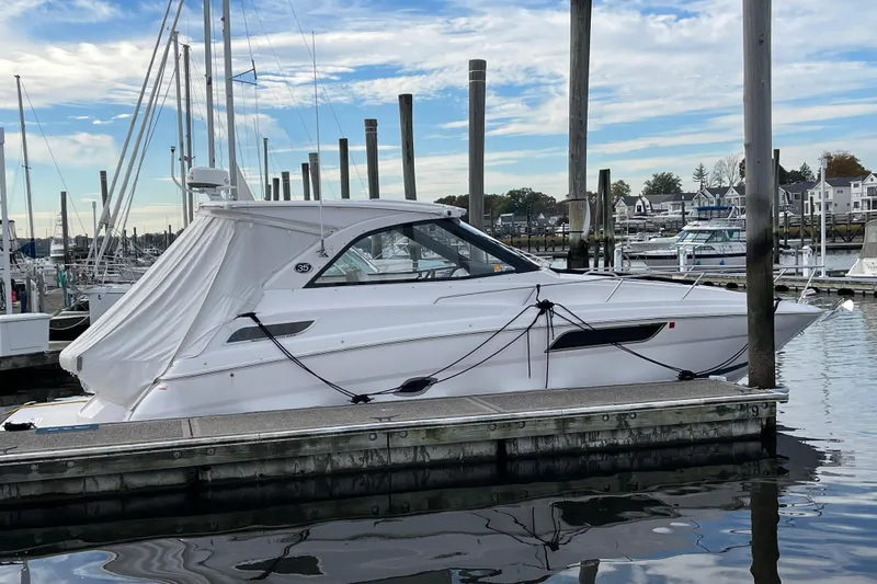 Slide: The Image of 2012 Regal 35 Sport Coupe docked at a marina, under a clear blue sky. - 5