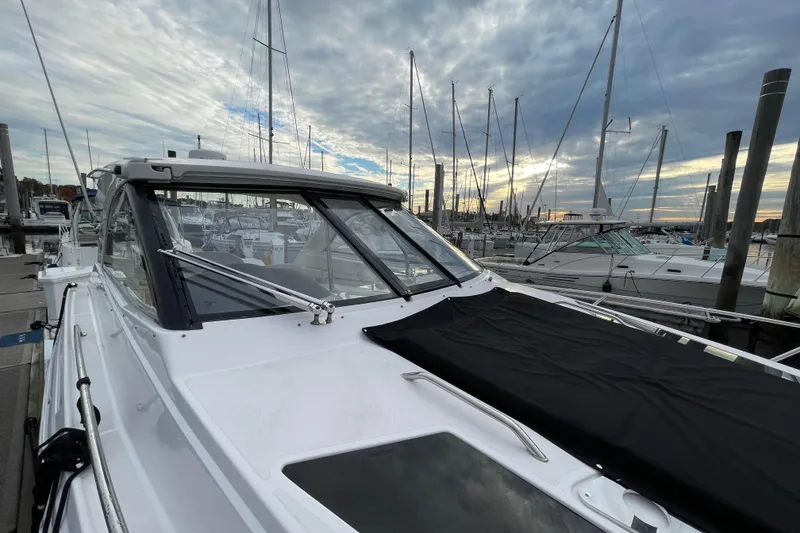 Slide: The Image of 2012 Regal 35 Sport Coupe docked at marina under cloudy sky. - 7