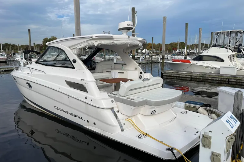 Slide: The Image of 2012 Regal 35 Sport Coupe docked at marina, showcasing sleek design and modern features. - 9