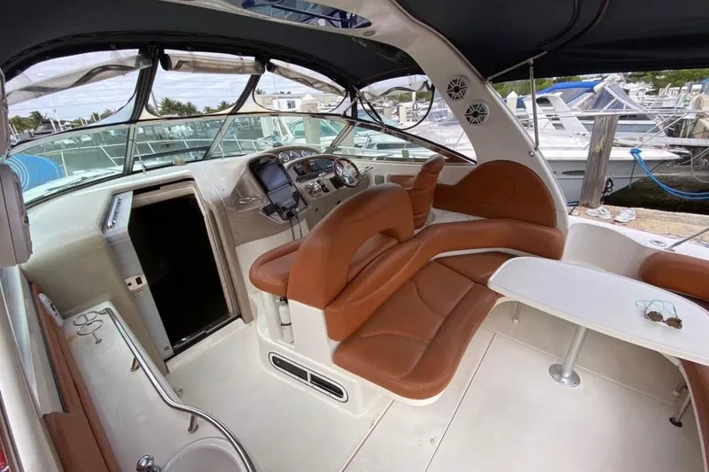 Slide: The Image of 2004 Sea Ray 380 Sundancer interior with brown leather seating and helm station. - 12