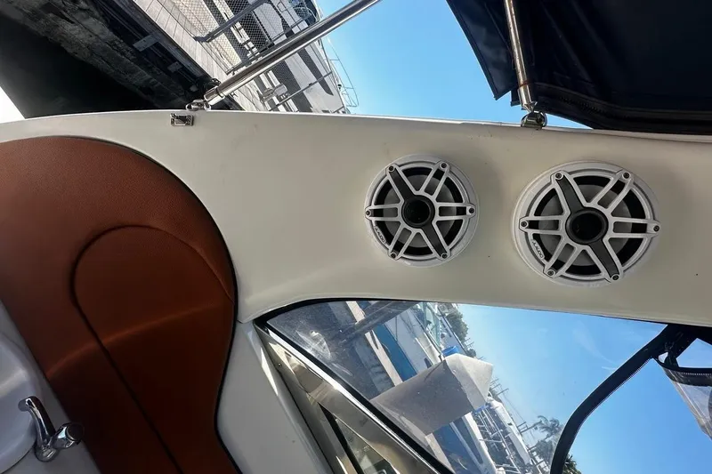 Slide: The Image of Interior of 2004 Sea Ray 380 Sundancer with dual speakers and leather seating. - 14