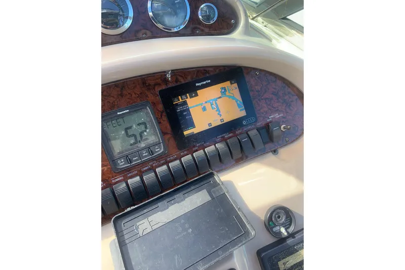 Slide: The Image of Dashboard of a 2004 Sea Ray 380 Sundancer with navigation and depth displays. - 15