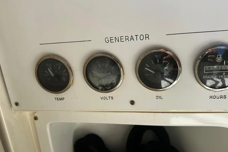 Slide: The Image of Control panel of a 2004 Sea Ray 380 Sundancer showing generator gauges. - 18