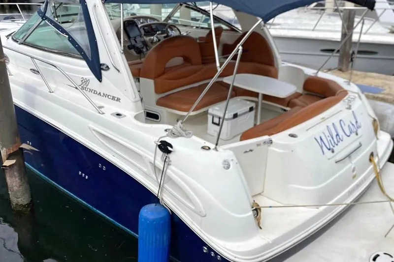 Slide: The Image of 2004 Sea Ray 380 Sundancer boat with blue hull and spacious seating area. - 3