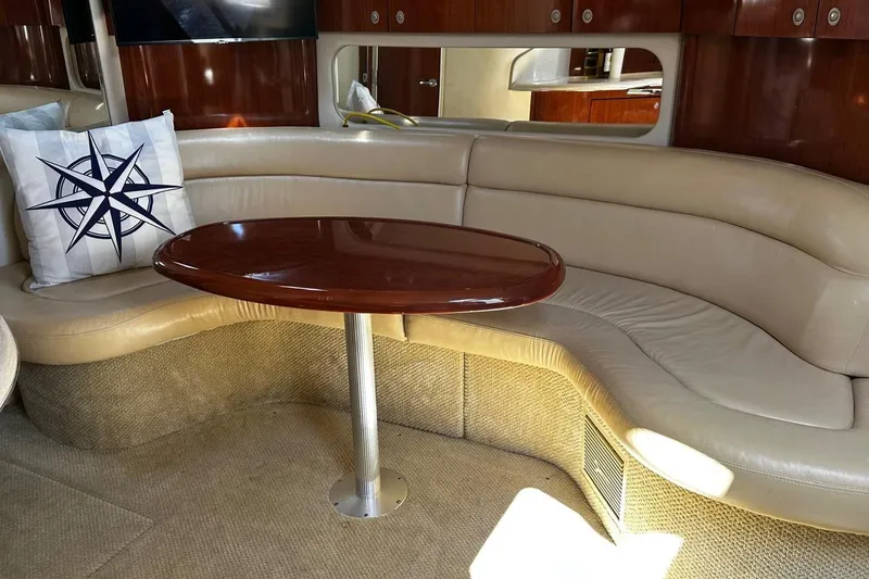 Slide: The Image of Luxurious interior of 2004 Sea Ray 380 Sundancer with leather seating and wooden table. - 8