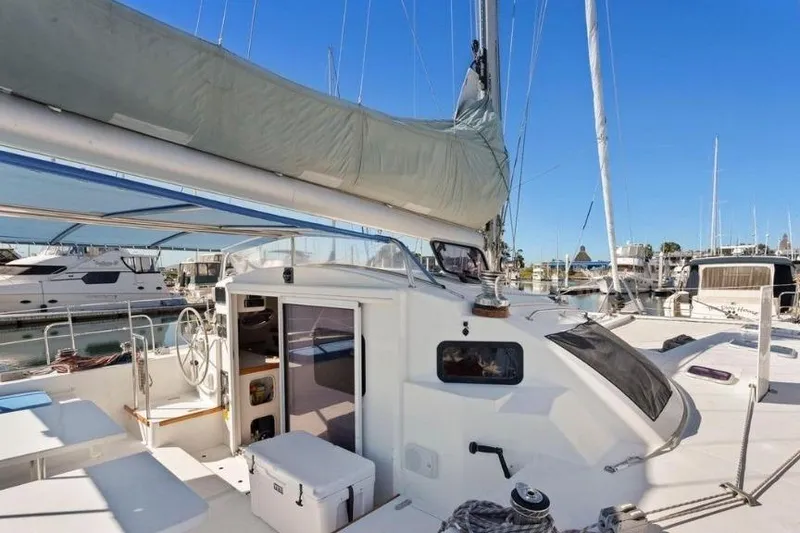 Slide: The Image of Outremer 55 Light 2002 sailboat docked at marina, showcasing cockpit and sail. - 10