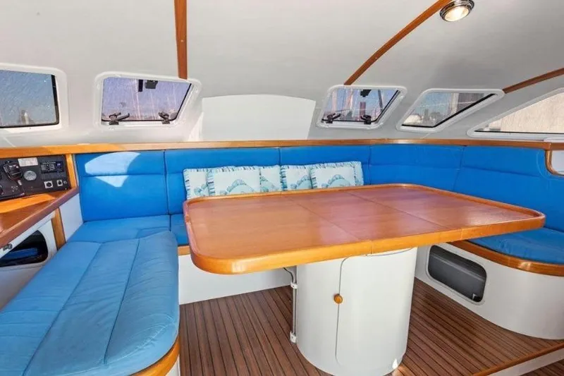 Slide: The Image of Interior of 2002 Outremer 55 Light yacht with blue seating and wooden table. - 13
