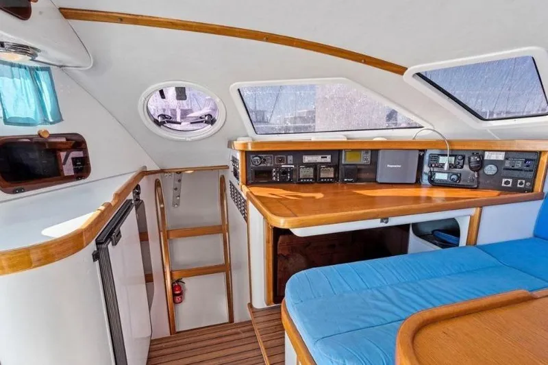 Slide: The Image of Interior of 2002 Outremer 55 Light yacht, featuring navigation equipment and wooden accents. - 16
