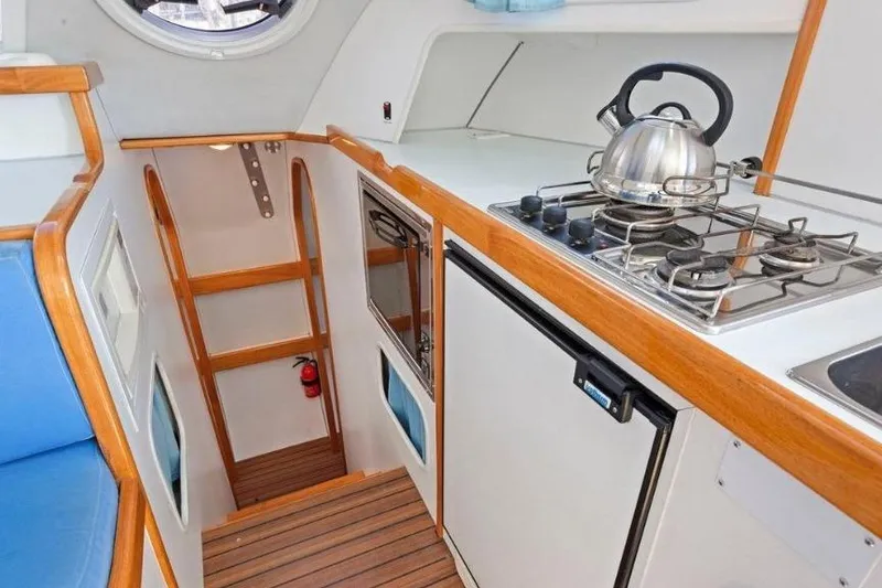 Slide: The Image of Interior of 2002 Outremer 55 Light yacht kitchen with stove and kettle. - 18