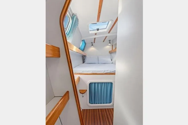 Slide: The Image of Cozy cabin interior of 2002 Outremer 55 Light yacht with skylight and wooden accents. - 19