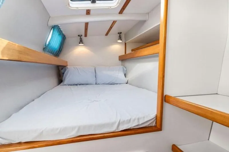 Slide: The Image of Cozy cabin interior of 2002 Outremer 55 Light yacht with comfortable bed and wooden accents. - 20