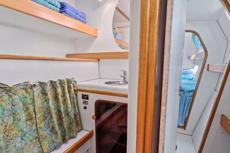 Slide: The Image of Interior of 2002 Outremer 55 Light yacht with sink, mirror, and storage shelves. - 21