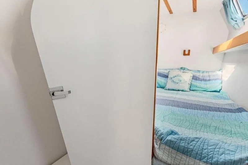 Slide: The Image of Cozy cabin interior of 2002 Outremer 55 Light yacht with striped bedding. - 22