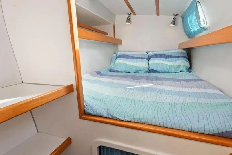 Slide: The Image of Cozy cabin interior of 2002 Outremer 55 Light yacht with striped bedding. - 27
