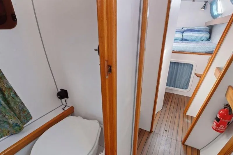 Slide: The Image of Interior of 2002 Outremer 55 Light yacht, featuring a compact bathroom and cozy sleeping area. - 30