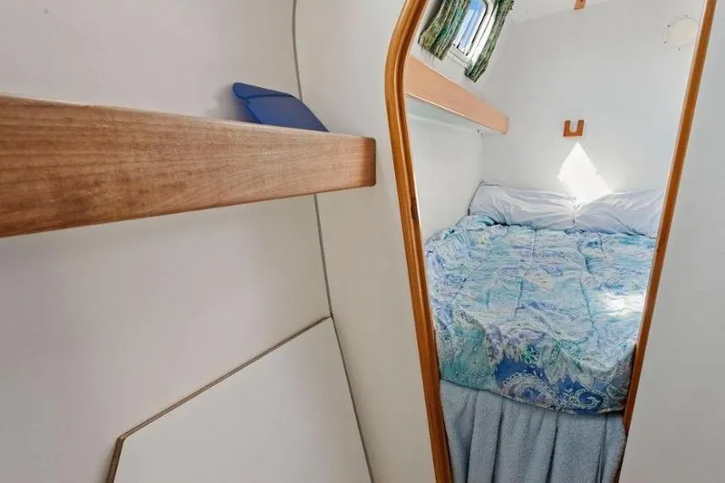 Slide: The Image of Cozy cabin interior of 2002 Outremer 55 Light yacht with bed and wooden accents. - 31