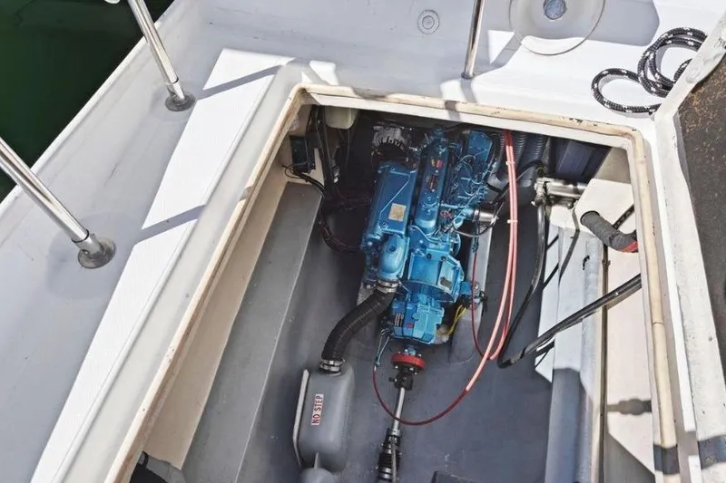 Slide: The Image of Engine compartment of 2002 Outremer 55 Light sailboat, showcasing blue engine and components. - 33