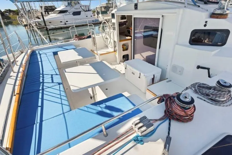 Slide: The Image of Spacious deck of 2002 Outremer 55 Light yacht with seating and tables. - 5