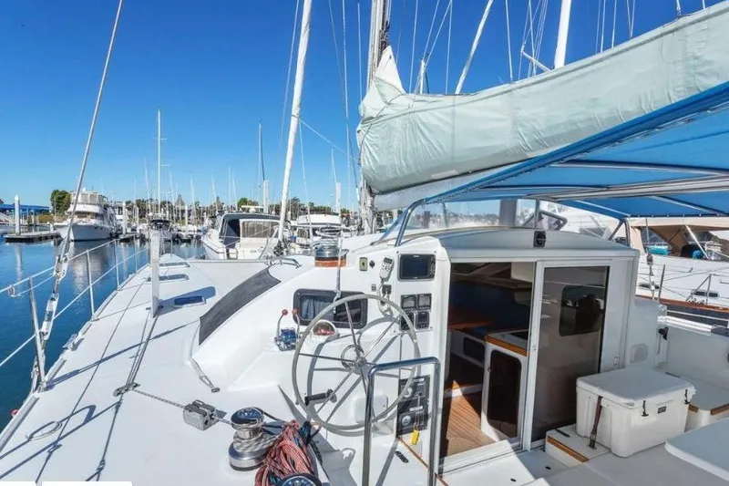 Slide: The Image of 2002 Outremer 55 Light catamaran docked at marina, featuring spacious deck and cockpit. - 9