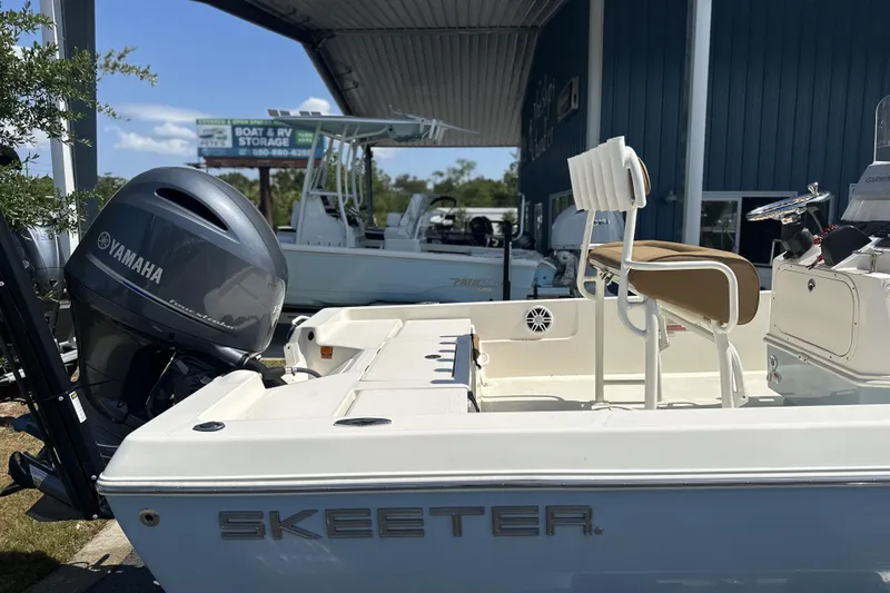 Slide: The Image of 2023 Skeeter SX210 boat with Yamaha engine at a storage facility. - 11