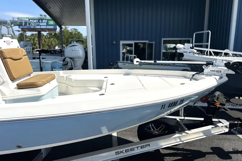 Slide: The Image of 2023 Skeeter SX210 boat on trailer, featuring Minn Kota trolling motor. - 4