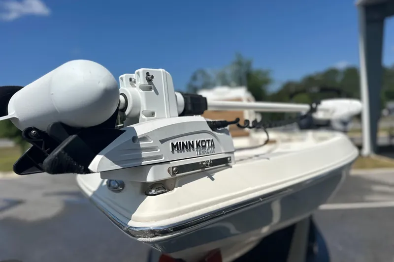 Slide: The Image of 2023 Skeeter SX210 boat with Minn Kota Terrova trolling motor, outdoor setting. - 7