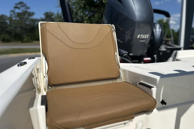 Slide: The Image of 2023 Skeeter SX210 boat seat with tan upholstery and visible outboard motor. - 8