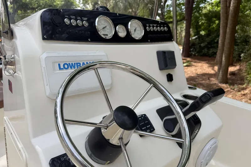Slide: The Image of 2023 Pioneer 180 Islander boat dashboard with steering wheel and Lowrance equipment. - 13