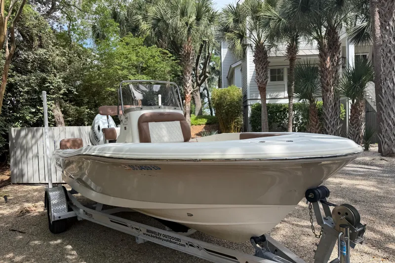 Slide: The Image of 2023 Pioneer 180 Islander boat on trailer, surrounded by palm trees. - 4