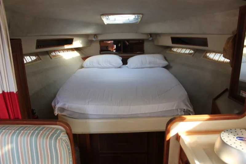 Slide: The Image of Interior cabin of 1986 Searay 340 Express with cozy bed and natural lighting. - 13