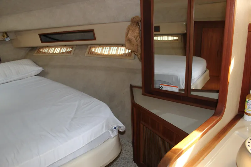 Slide: The Image of Interior cabin of 1986 Searay 340 Express boat with bed and mirrored cabinet. - 15