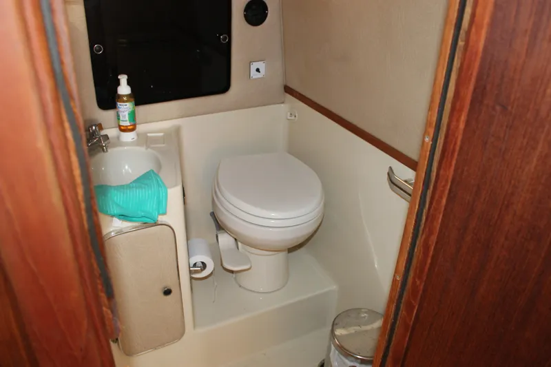 Slide: The Image of Compact bathroom in 1986 Searay 340 Express boat with toilet and sink. - 19