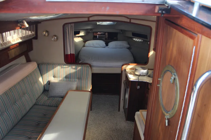 Slide: The Image of Interior of 1986 Searay 340 Express boat with cozy seating and sleeping area. - 20