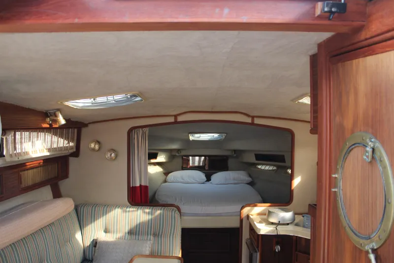 Slide: The Image of Interior of 1986 Searay 340 Express boat with cozy cabin and bed. - 21