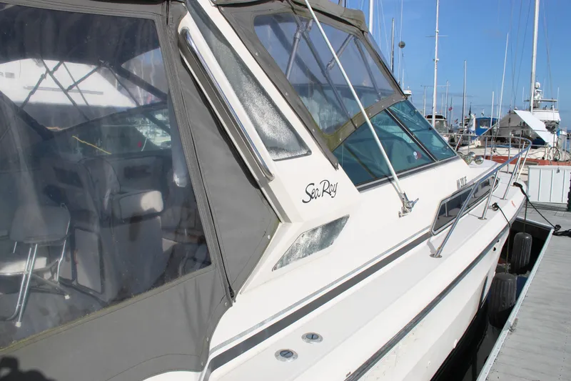 Slide: The Image of 1986 Searay 340 Express boat docked at marina, featuring sleek design and spacious interior. - 4