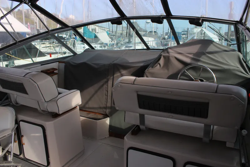 Slide: The Image of Interior view of a 1986 Searay 340 Express boat cockpit with covered controls. - 5