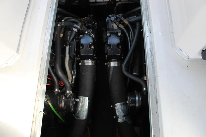 Slide: The Image of Engine compartment of a 1986 Searay 340 Express boat, showing dual engines and hoses. - 6